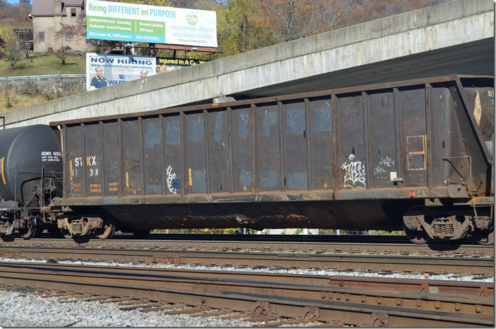 STKX (Strickland Trading Inc.) gon 1133 passing Williamson WV, on an e/b NS freight 392-12, 11-12-2021. 4,400 cubic feet, 211,100 lbs., built 1981. Ex-SULX. At least the scrap probably won’t fall through the hole in the bottom!