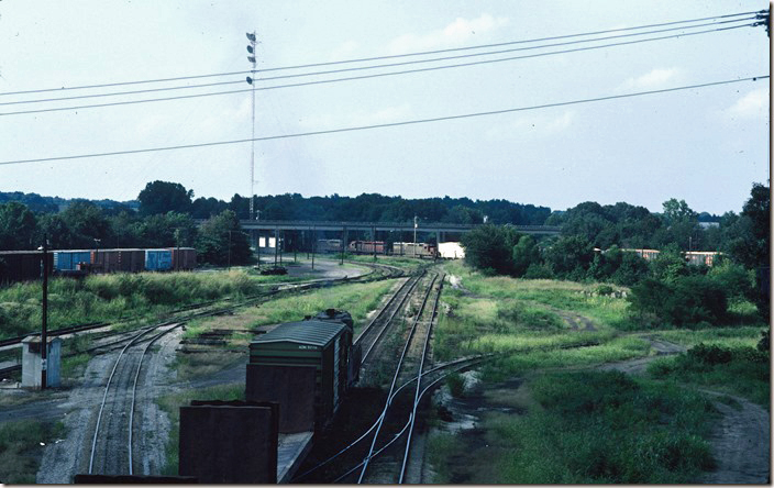 As the yard engine switches in the foreground BC-4 arrives northbound on the Cairo District. 08-09-1986. ICG. Fulton KY.