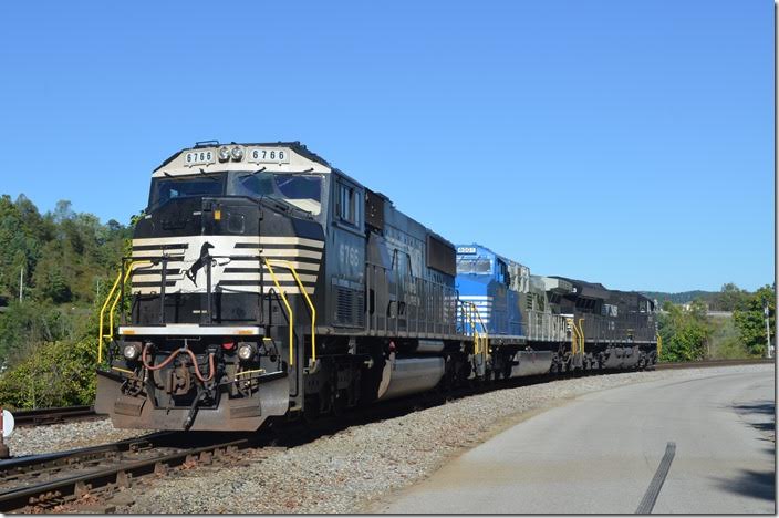 The crew of U49 backs NS 6766-4001-3613 east toward the signal on the Clinch Valley end. 6766 is a SD60M. Norton VA. View 3.