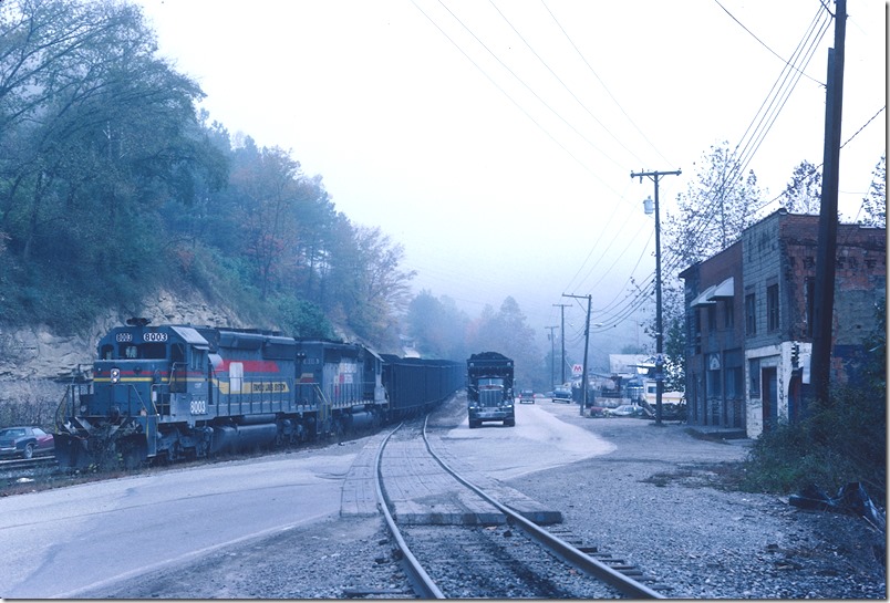 Hazard No. 8 has his train together and is ready to depart down the hollow for North Hazard Yard. L&N and CSX call this wye “Duane”, but various maps call it Bulan. The post office is Bulan. KY 476 seen here is old KY 80 between Hazard and Hindman. New KY 80 is 4-lane. In the foreground is the connecting track of the wye to the Jake’s Branch side. L&N Lotts Creek.