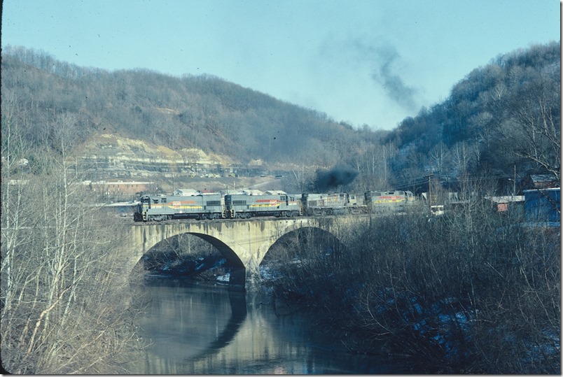 Hazard No. 1 crosses the concrete arch bridge over the North Fork of the Kentucky River at Walkertown heading for North Hazard yard. 02-14-1982. L&N Lotts Creek.
