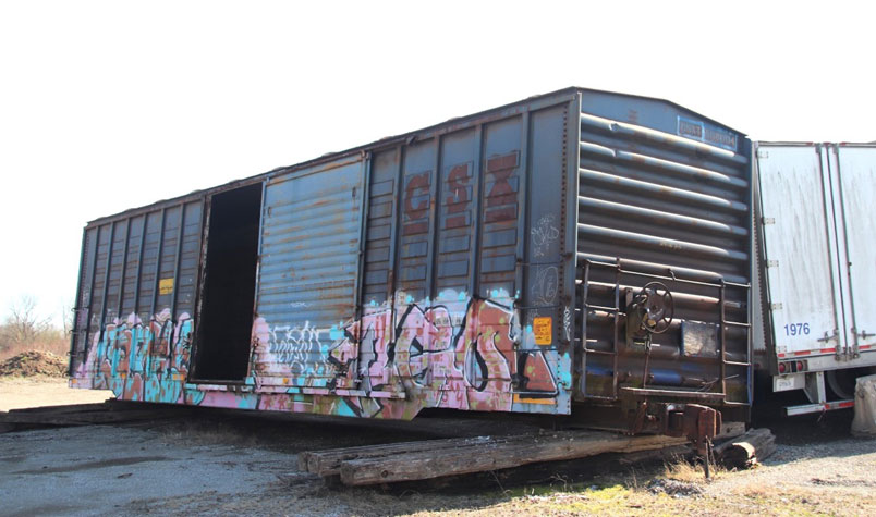 CSXT 508004 in farm supply storage lot.at Worthville, Kentucky.