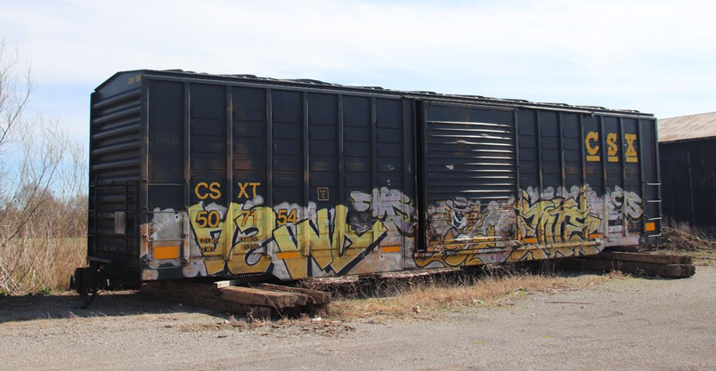 CSXT 507154 in the farm supply storage lot.at Worthville, Kentucky.