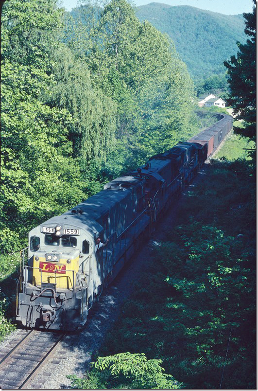 We get a wave from the head brakeman as the Lynch Turn drops downgrade through Clutts. Only track here now is for walking. L&N 1559 Lynch Turn-Clutts.