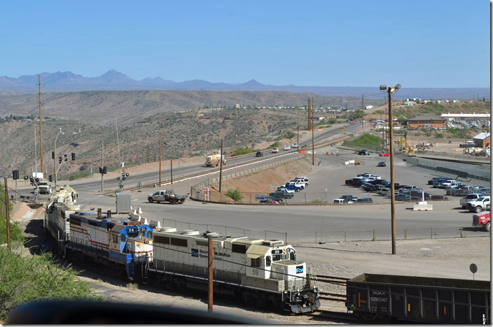 Locomotives!! They weren’t here when we drove up. Part of Morenci is in the background. The brick building is a F-M office. I’m shooting out the car window while stopped on US 191. We’re looking at one of the busy gates to the plant. F-M 59-56-50. Morenci AZ.