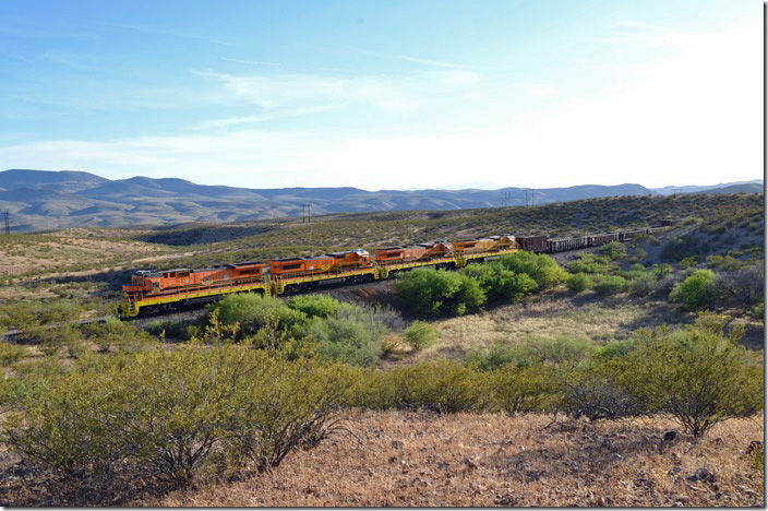 I heard engines idling and looked to the north. A dimmed headlight revealed a train. It wasn’t moving, so we drove down the dusty access road to check it out. AZER 4000-2322-4003-4011 were parked with a train. The SP timetable special instructions reveal that the grade was very steep both directions from South Siding, and speed limits reinforce that. Perhaps G&W’s choice of B39 and B40 units with extended range high capacity dynamic brakes was predicated by the steep grades between Guthrie and Clifton. South Siding AZ.