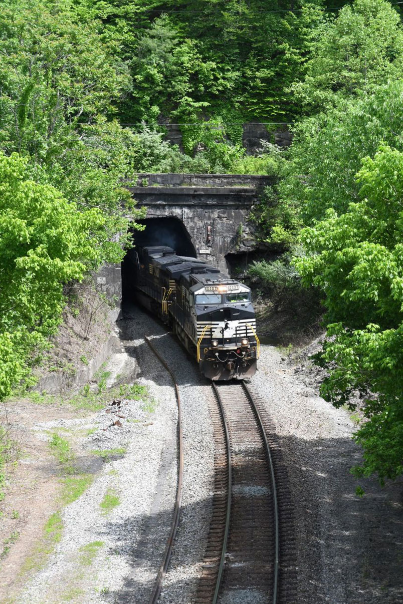 Panco signals line up for a westbound. We head around to the Kermit side of Tunnel #1. No. 51V-16 burst out of the notched tunnel portal. Today 51V has 41 time freight empties plus 104 grain empties for a total of 145 cars. The grain cars are going to Milford, IN.