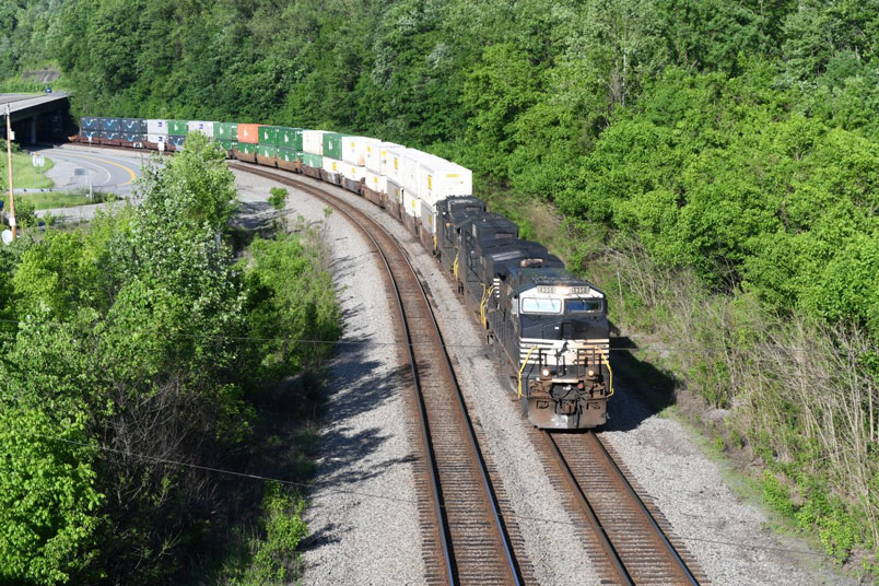 Hot e/b 28N-18 (Chicago Calumet - Charlotte) has 20/1 for Charlotte and 8/1 for Greensboro for a total of 28/2. US 119 4-lane is to the far left. US 52 diverges here for Huntington. We shot this from the old US 52 bridge near Maher (named after a N&W president).