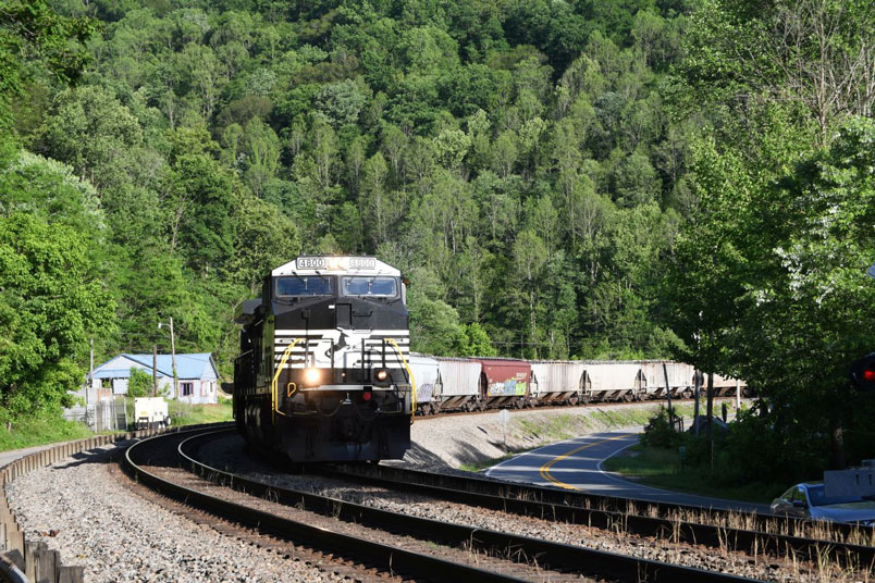 It's getting late, and I want to get home! But the trains keep coming! No. 119-17 (Linwood-Bellevue) has 39/78. DPU 4569 is in there 9/46 from the rear. US 52 crossing near Maher.