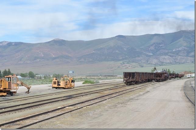 Ore was put in this small yard just east of the station and shop. The main line north to Cobre (junction with Southern Pacific) and McGill (concentrator and smelter) is along the base of the mountain in the distance.