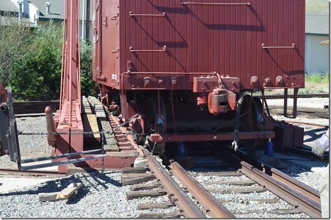 Using a fork lift, they gradually pull the jacked-up wheels back onto the track. No problem. View 5.