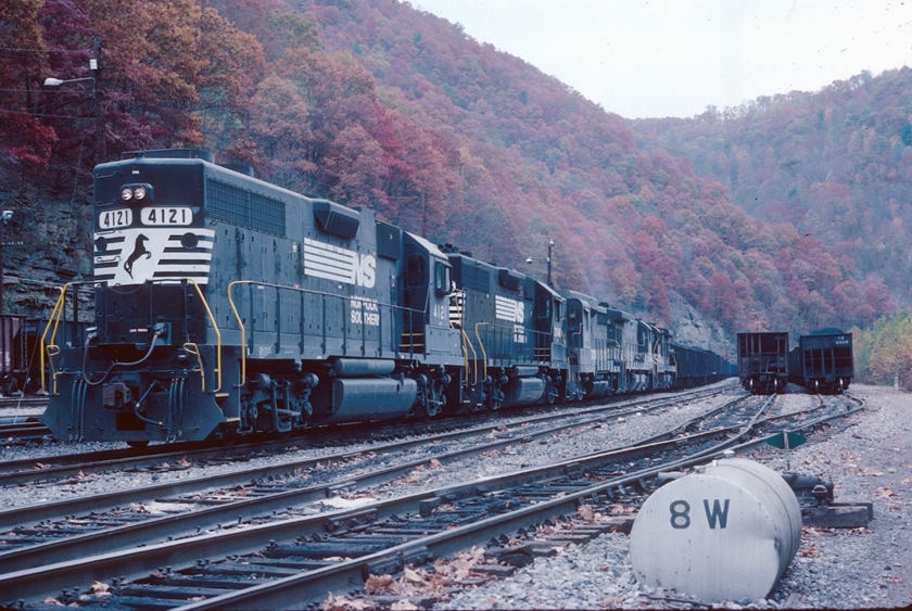 GP38AC 4121 was built for N&W in 1971 with dual control stands. The long end was considered forward. This was a model between the GP38 and GP38-2. Southern bought a bunch of 38-2s! I think "8W" is one of many air-activated switches throughout the yard. They're gone now. 10-25-1987.