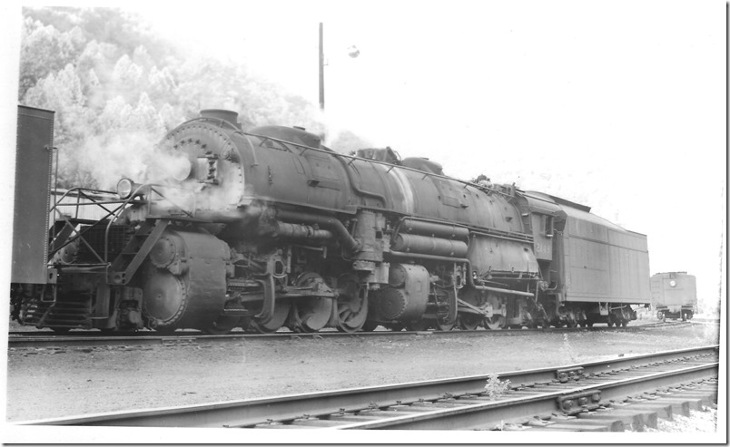 N&W 2149 simmers at Weller Yard VA., on 05-31-1959. N&W used the giant Worthington model BL feed-water heater on its 4-8-2s, most 2-6-6-2s and all 2-8-8-2s from classes Y-3 to Y-6a. They used the Worthington model SA on the class A 2-6-6-4s, J 4-8-4s and the Y-6b. In contrast C&O preferred the Elesco tube bundle type so familiar on their Mikes, Pacifics and 2-8-8-2s, but they also liked the Worthington S and SA models on their newer steam locomotives. The feed-water heater uses exhaust steam and fire box gasses to pre-heat the water before it goes into the boiler. R. L. Harvey collection.