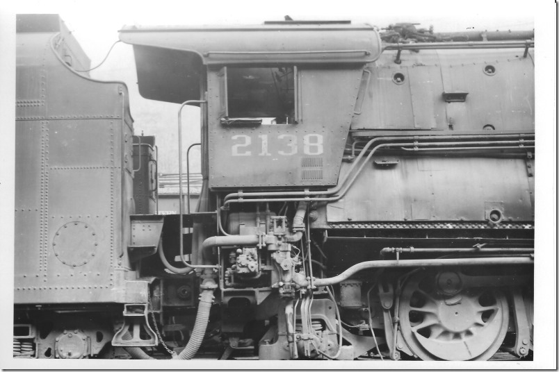 That is probably the injector apparatus under the cab. The round bolted access hatch on the tender probably provides access to the stoker motor. I’m not sure on these. N&W 2138. Weller VA. 11-22-1959. R. L. Harvey collection.