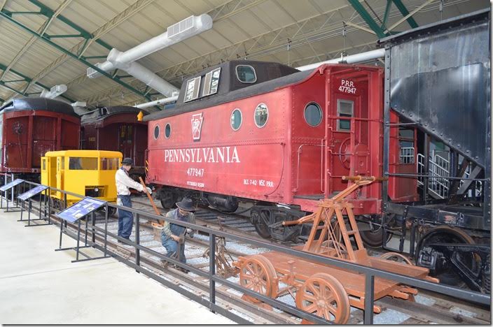 PRR “cabin” car 477947. Track gang in foreground.