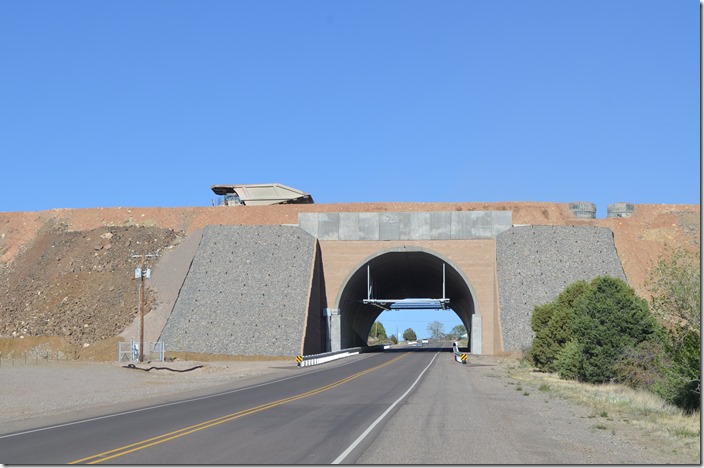 At Hanover we turn east off NM 356 onto NM 152 to check out the Chino (aka Santa Rita) open pit copper mine overlook. Freeport-MaMoRon has built this overpass for their big end-dumps to access a new area. This truck appears to be heading north toward Fierro empty, so presumably it comes back south with ore. Chino Mine haul road. Hanover NM.