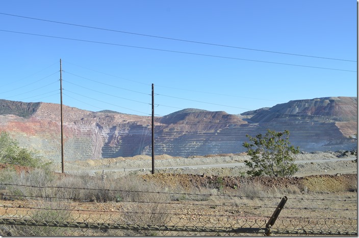 The overlook was closed because the edge is breaking off into a haul road. However I climbed the slope above the road and took this. Look at Google Maps to see the enormity of this open pit mine. Chino Mine pit near Hanover NM.