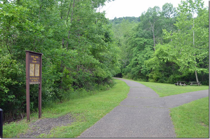 Sandy Creek rail trail veering off to the left. Parking to the right. Belmar PA.