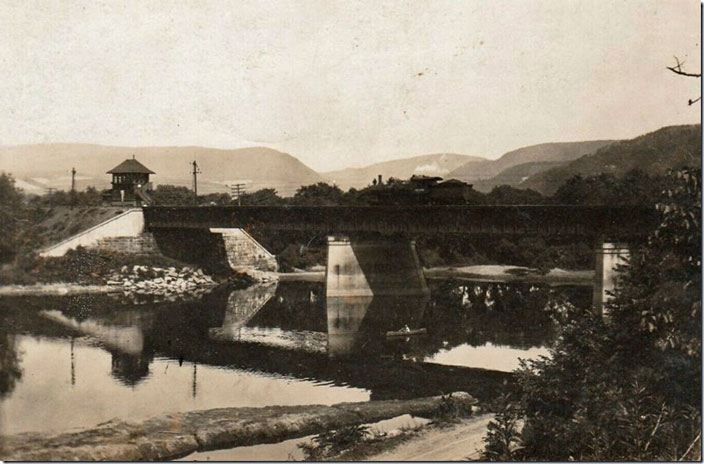 Could be YA Tower between Jersey Shore Jct. and Avis Yard. Stream probably Pine Creek, as it is too small to be the Susquehanna River. Note the engine on the bridge. NYC scene Avis PA 1911.