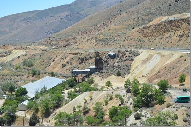 The area to the left of the Crown Point Mine was once the site of the huge Crown Point wooden trestle. Subsequent mining eventually filled the gully with waste material. Yellow Jacket Mine Gold Hill NV.