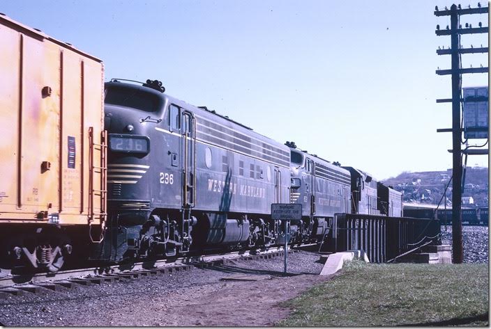 The westbound freight crosses the Potomac River. In the background is the interchange track to the B&O. WM Ridgeley WV.