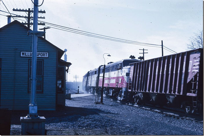 Here’s what I’m waiting for! The helper set roars by as they get a run at “Williamsport hill.” Some coal or other mineral traffic has been added to fill out tonnage. The engineer grabs for an order or message. Those FAs have plenty of horn! WM Williamsport MD.