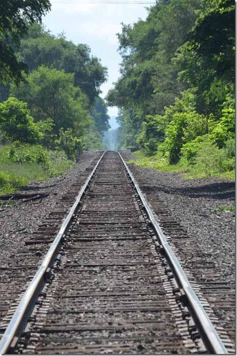 Looking east from West Lafayette on tangent track. In 1950, the PRR Panhandle main line was double track. The accident happened about a mile down the track. Basically the w/b troop train stopped because of brake problems. No. 31, the “Spirit of St. Louis”, ignored an approach signal and rear-ended the troop train which was stopped a few feet west of the red block signal. PRR 31 was headed by a pair of Baldwin BP20 passenger diesels. This lapse of operating rules resulted in the deaths of 33 soldiers. OC looking east from West Lafayette OH.